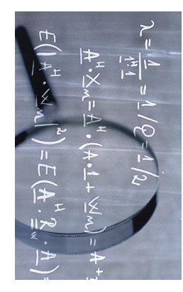 Scientific formulas superimposed on an image of a magnifying glass.